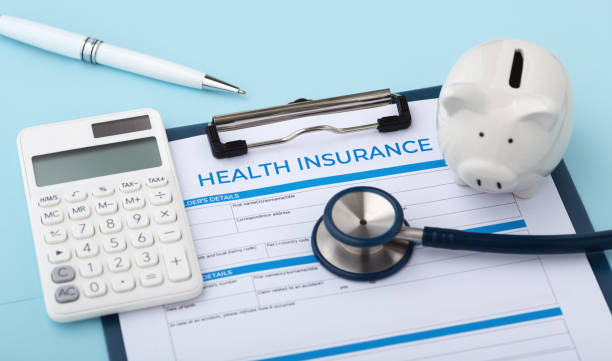 Health insurance document with calculator and piggy bank on blue background